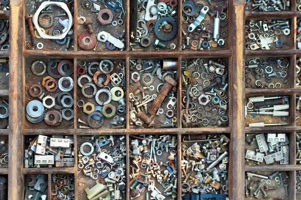 washers and bolts in a dirty divider