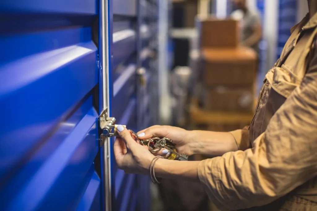 person locking a storage unit
