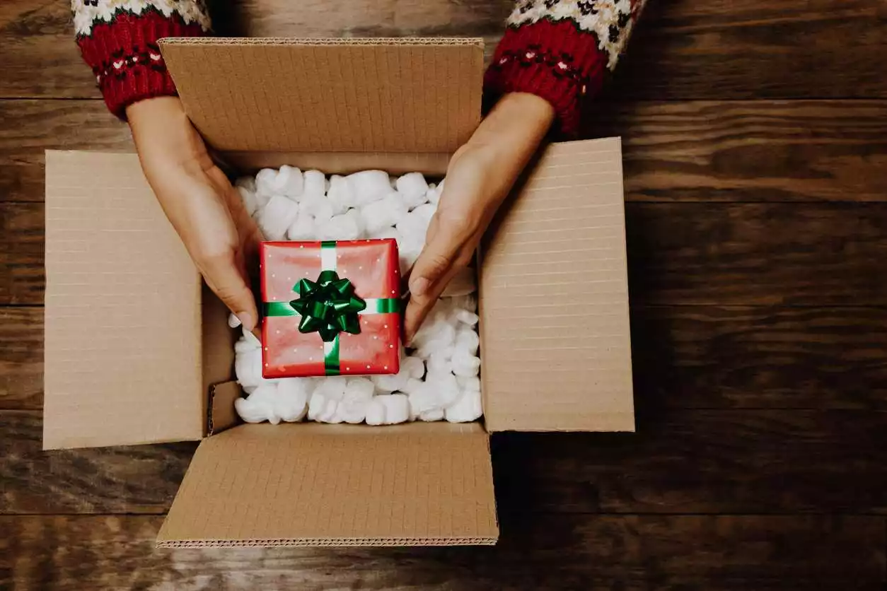 Christmas gift being stored away in a box for re-gifting