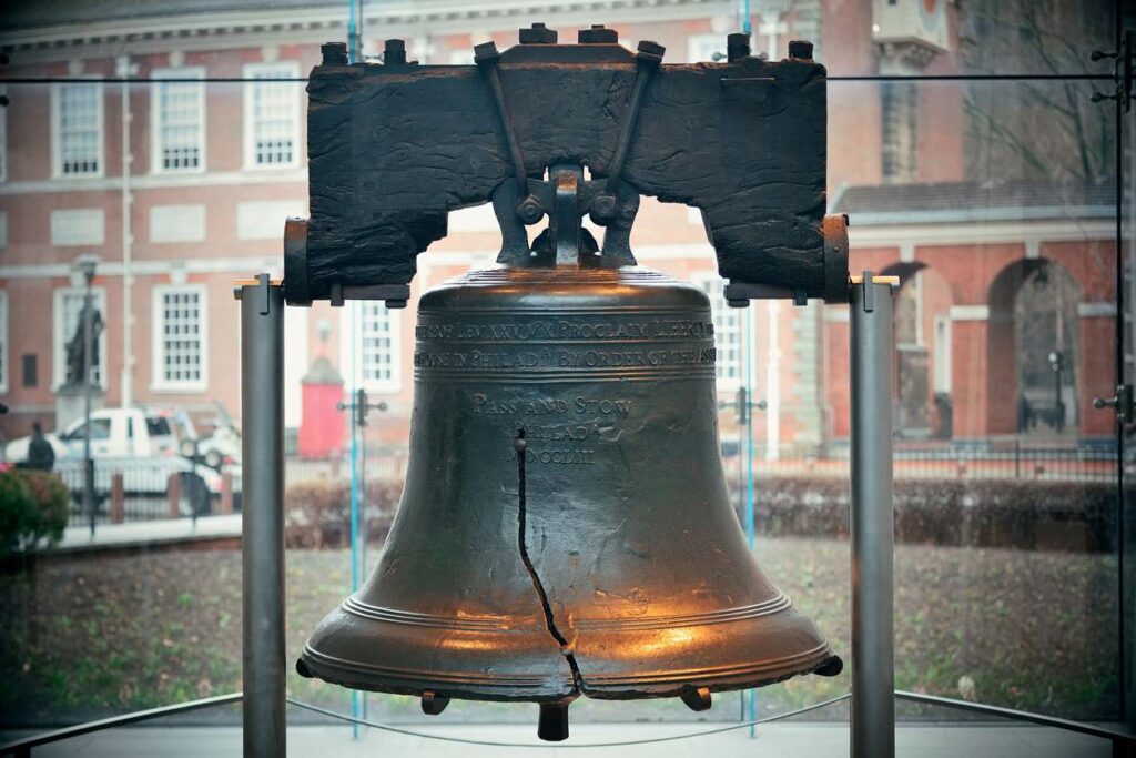 The Liberty Bell, a large copper bell with a crack down its middle, is on display